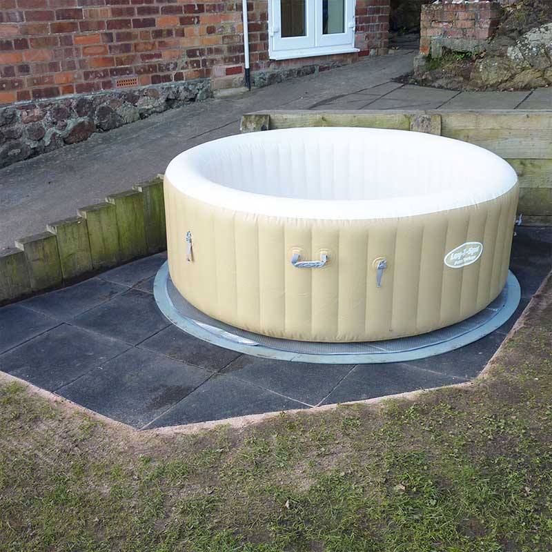 Inflatable hot tub installed on a protective garden base