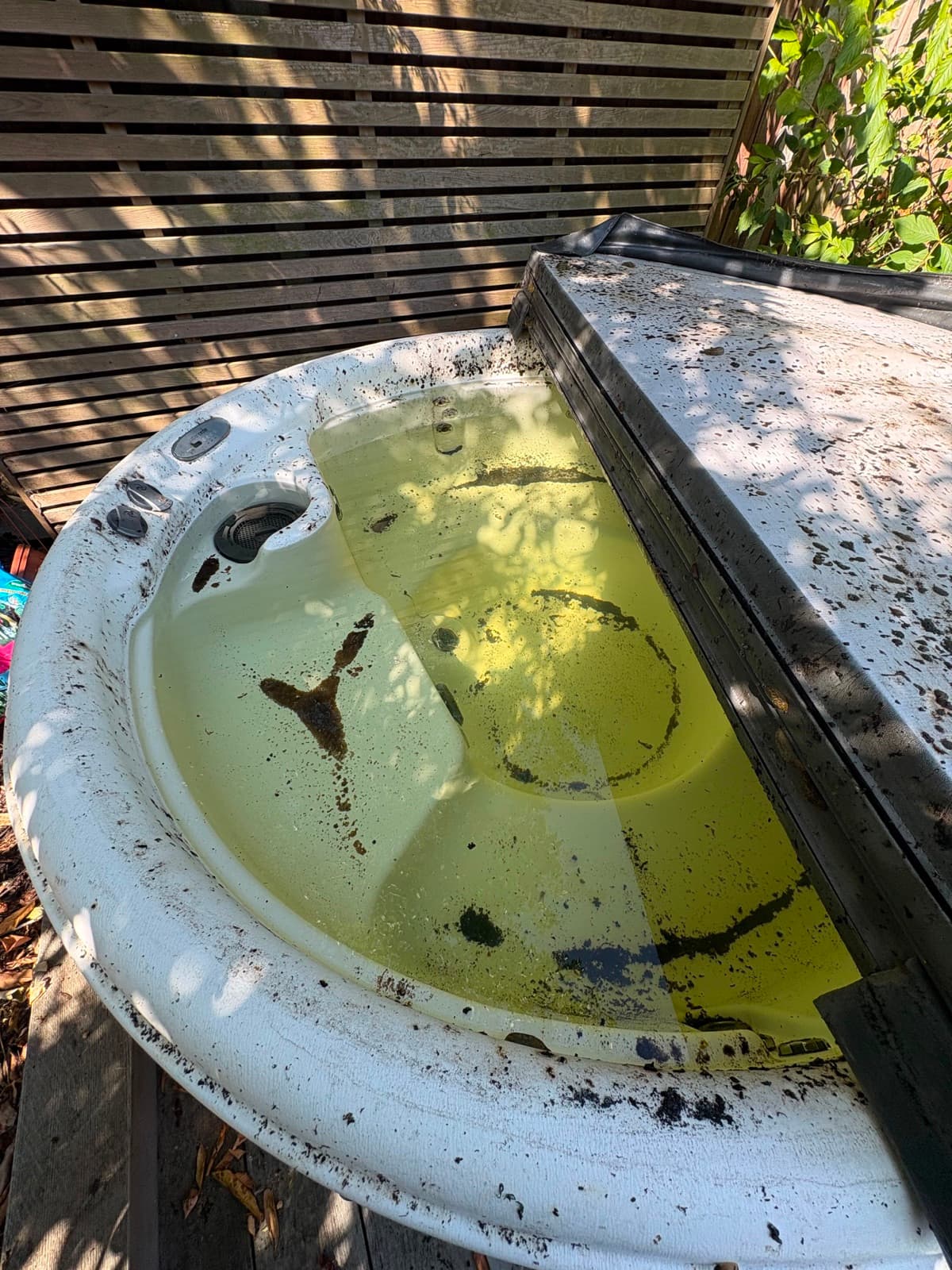 Dirty white spa before a J5 Spa Services cleaning visit